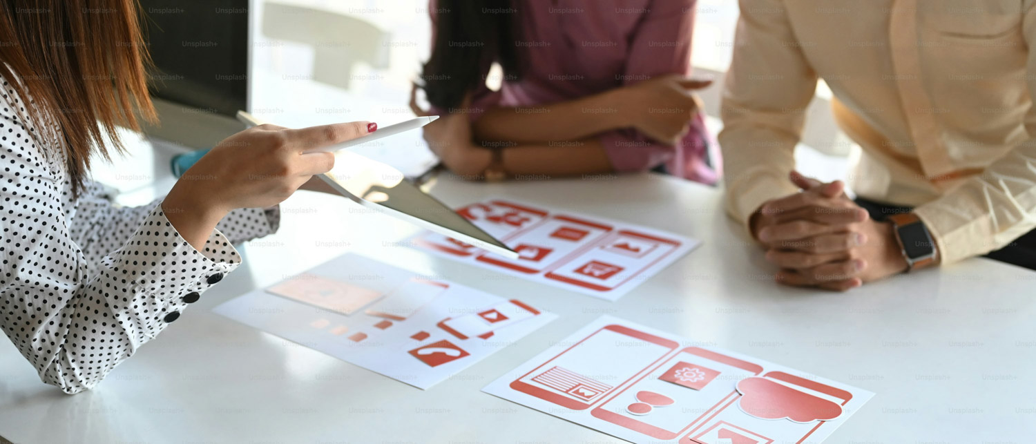 Group of ui ux creative designer planning application process development prototype for application on smartphone.